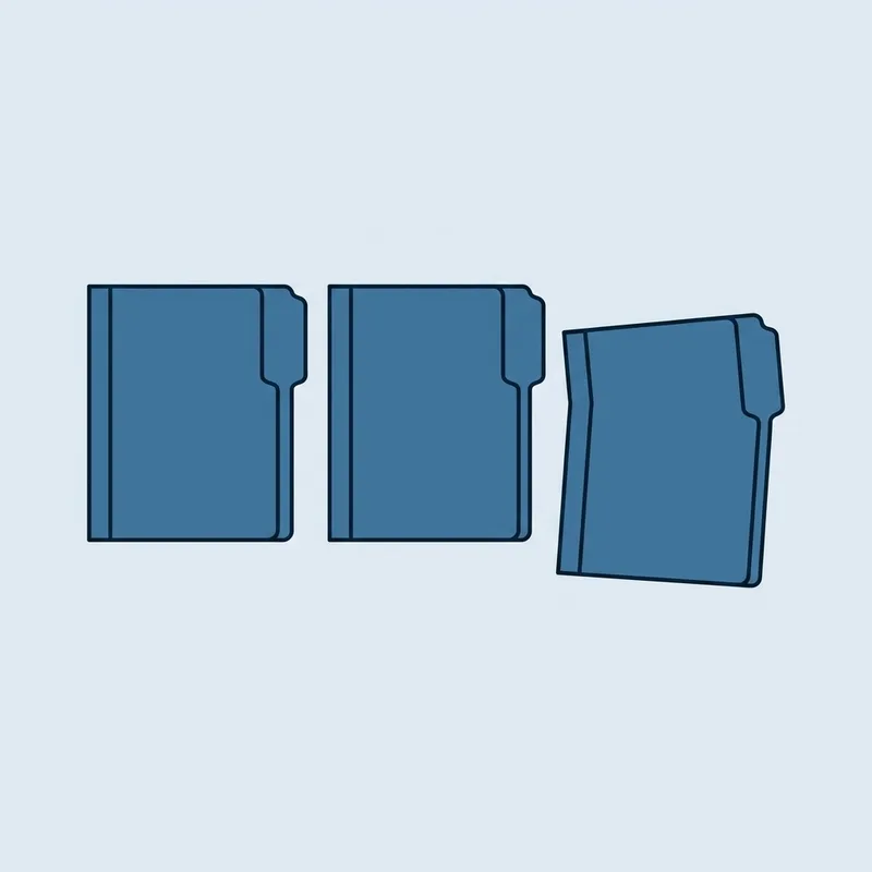 Three identical closed folders lying side by side on a plain surface, one of them slightly out of line